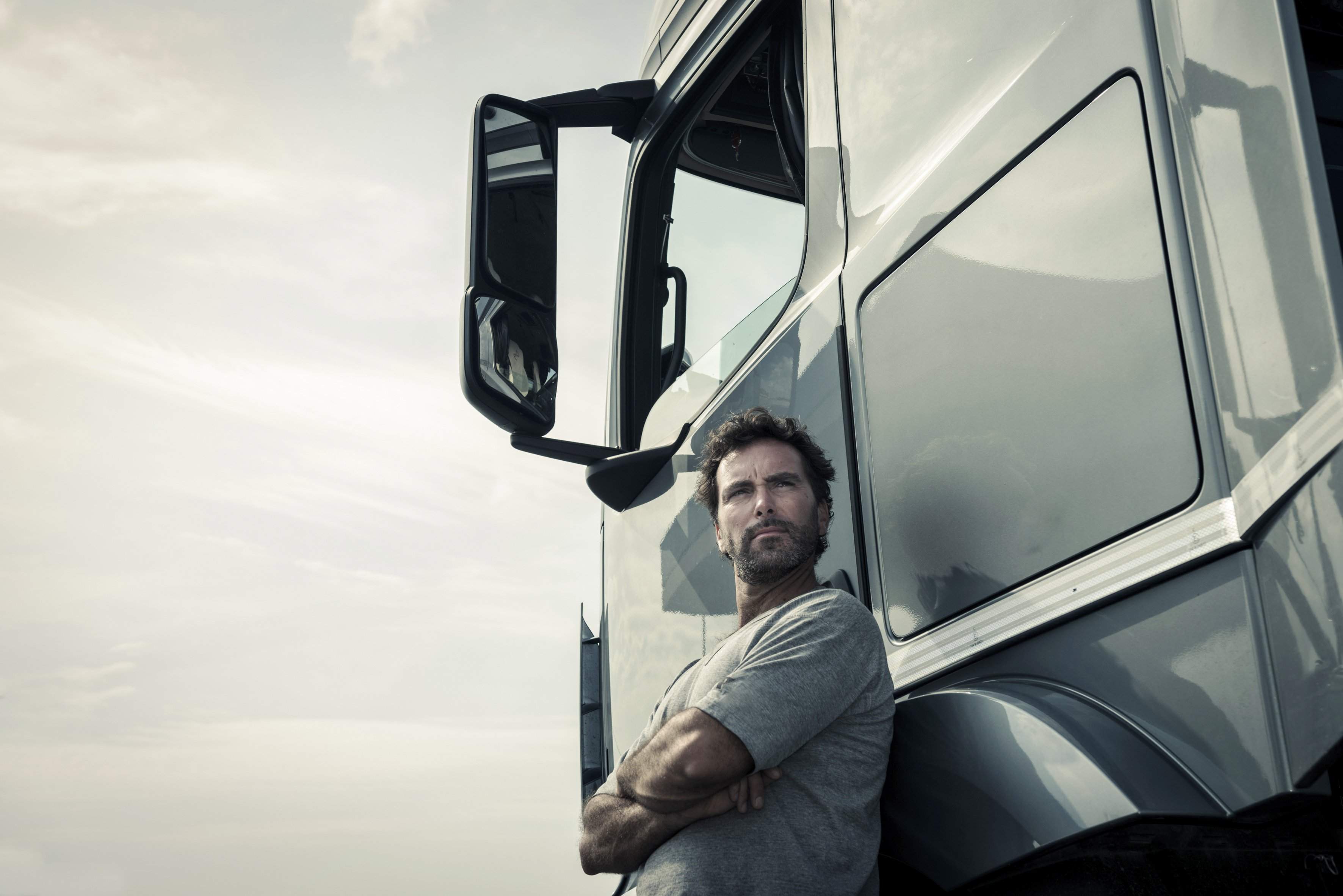 a man leaning on a truck