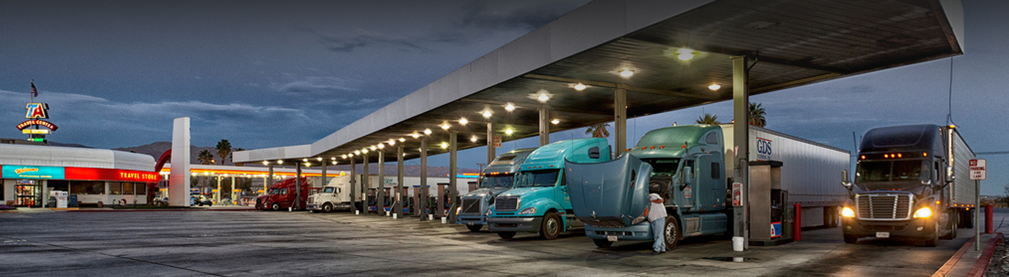 Trucks parked at a gas station.